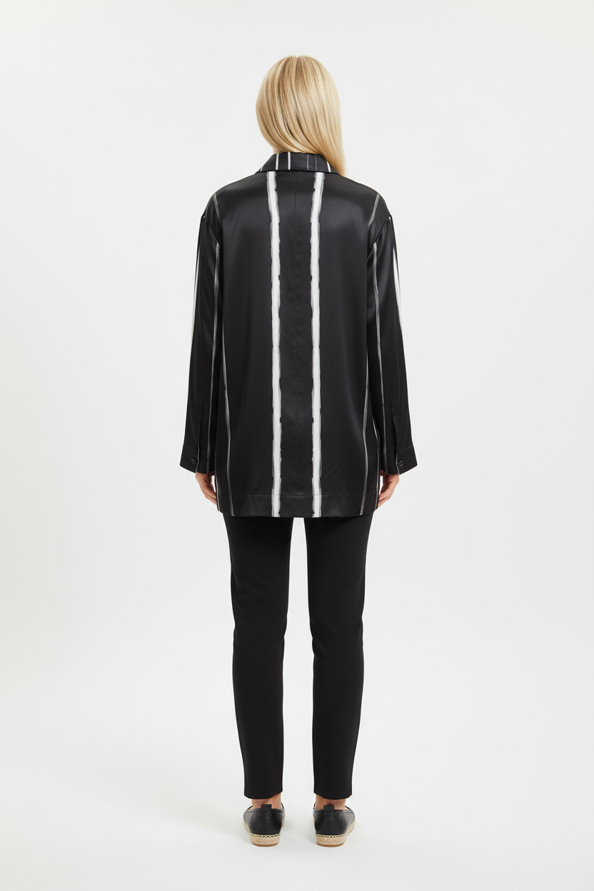Back view of a model wearing the NIMIAN Nocturna striped silk pyjama shirt